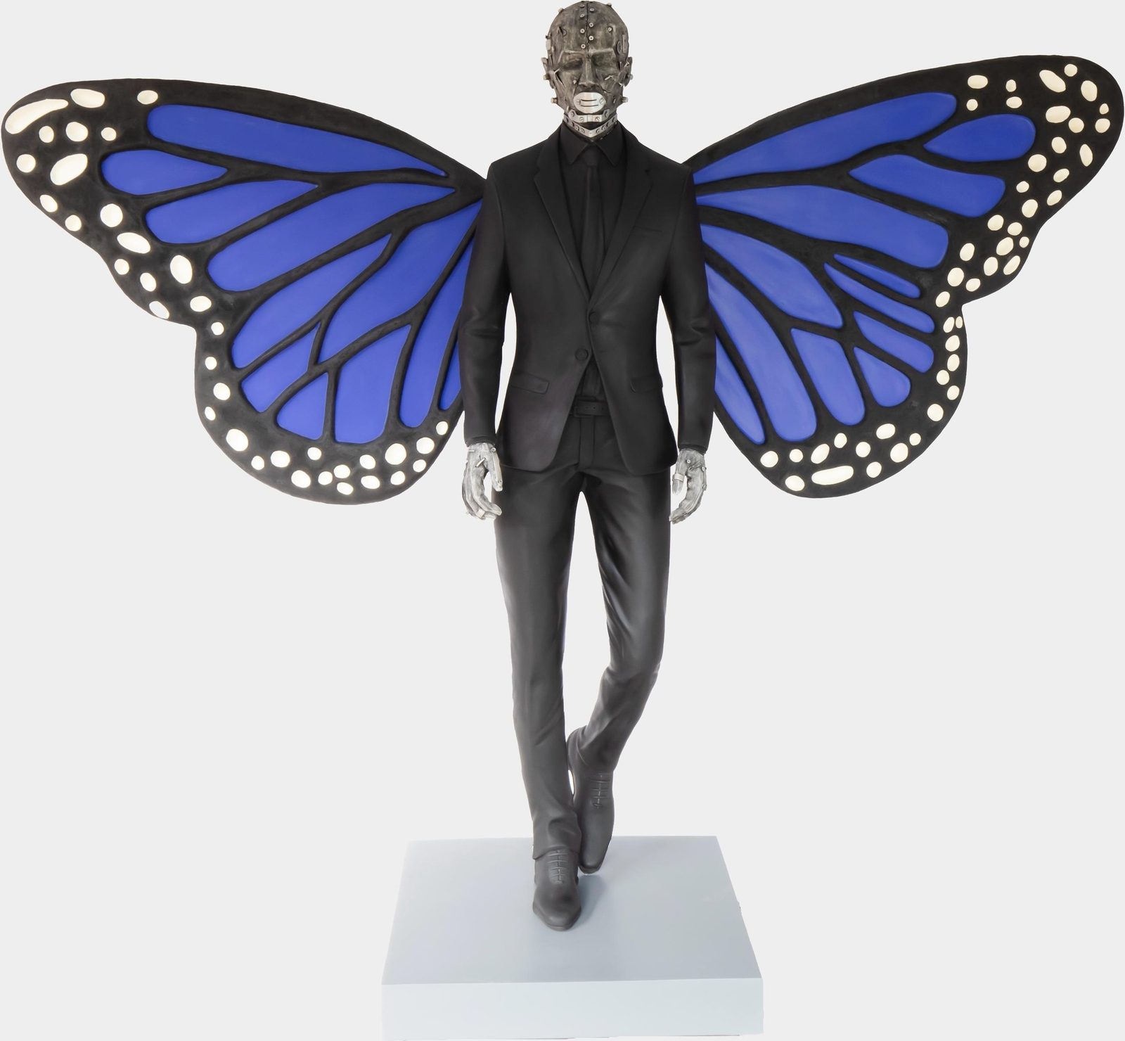 Phaneendra Nath Chaturvedi, The 41 Resurrection Lives: fibreglass figure of a man in a black suit with large blue-and-black butterfly wings, standing on a white plinth